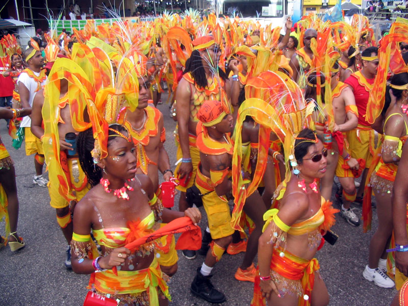 Carnival masqueraders in vibrant orange costumes in Trinidad