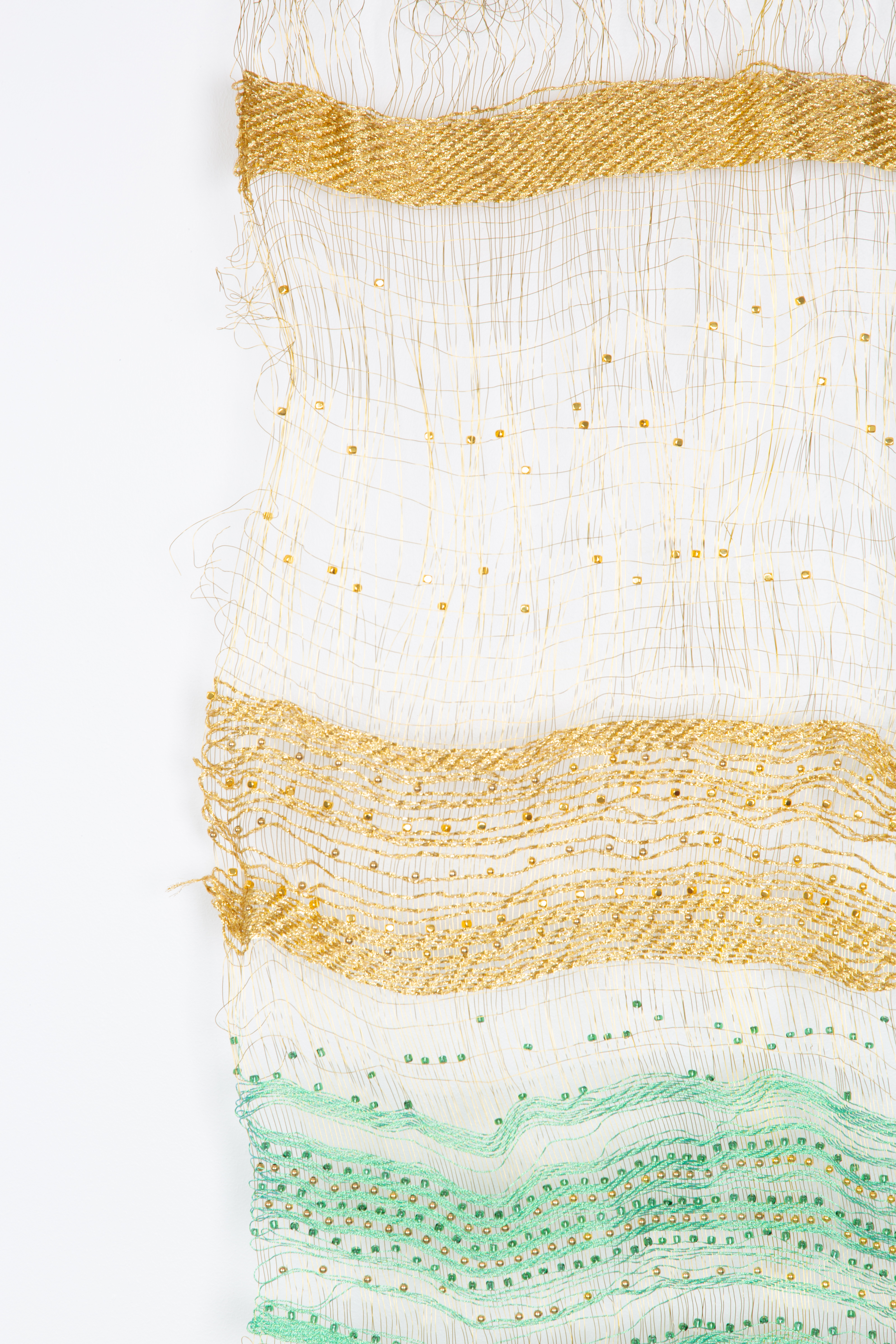 Close-up of Jannah &mdash; gold and green threads visible up close