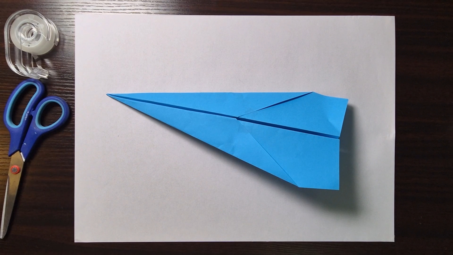 Folded paper airplane, traditional dart design